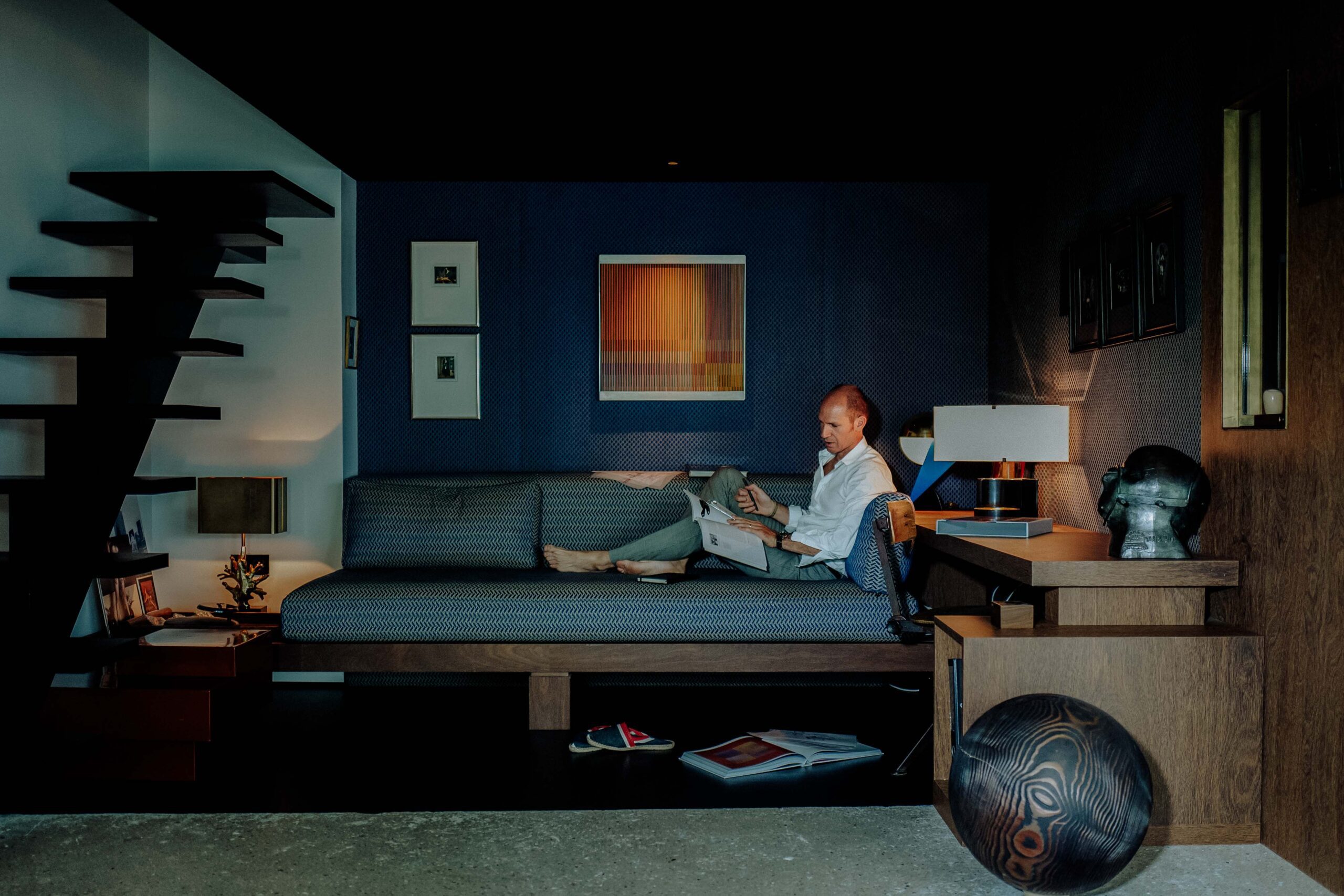 Portrait of Tristan Auer in his Montmartre home Portrait of French interior designer Tristan Auer seated in his Montmartre living room, surrounded by curated vintage furniture and natural light.
