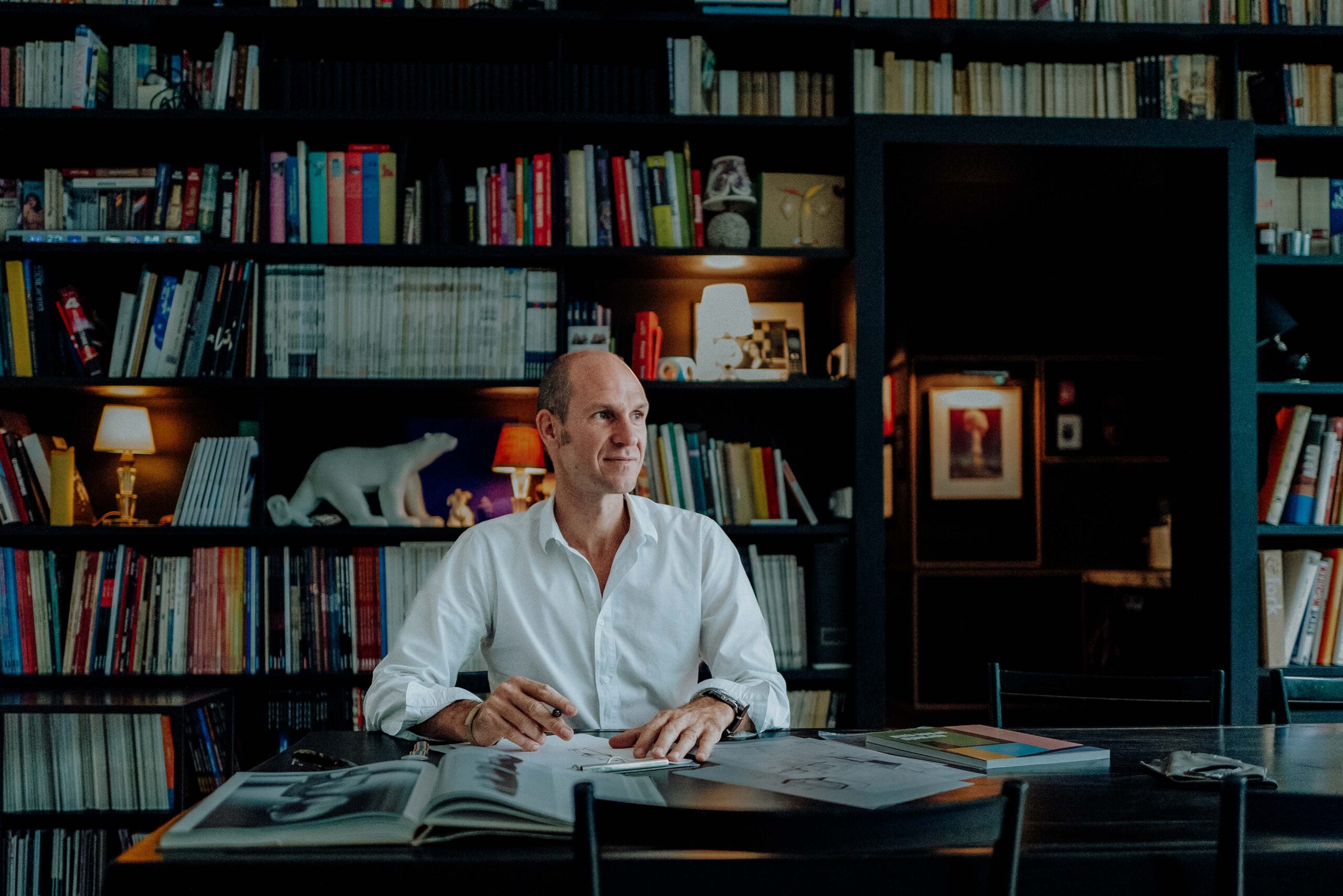 Portrait of Tristan Auer in his Montmartre home Portrait of French interior designer Tristan Auer seated in his Montmartre living room, surrounded by curated vintage furniture and natural light.