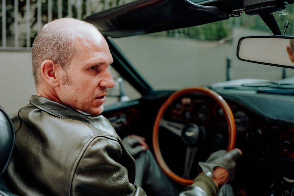 In-car shot while driving through Paris Interior view of Tristan Auer’s vintage Aston Martin as he drives through central Paris, captured during a candid lifestyle shoot.