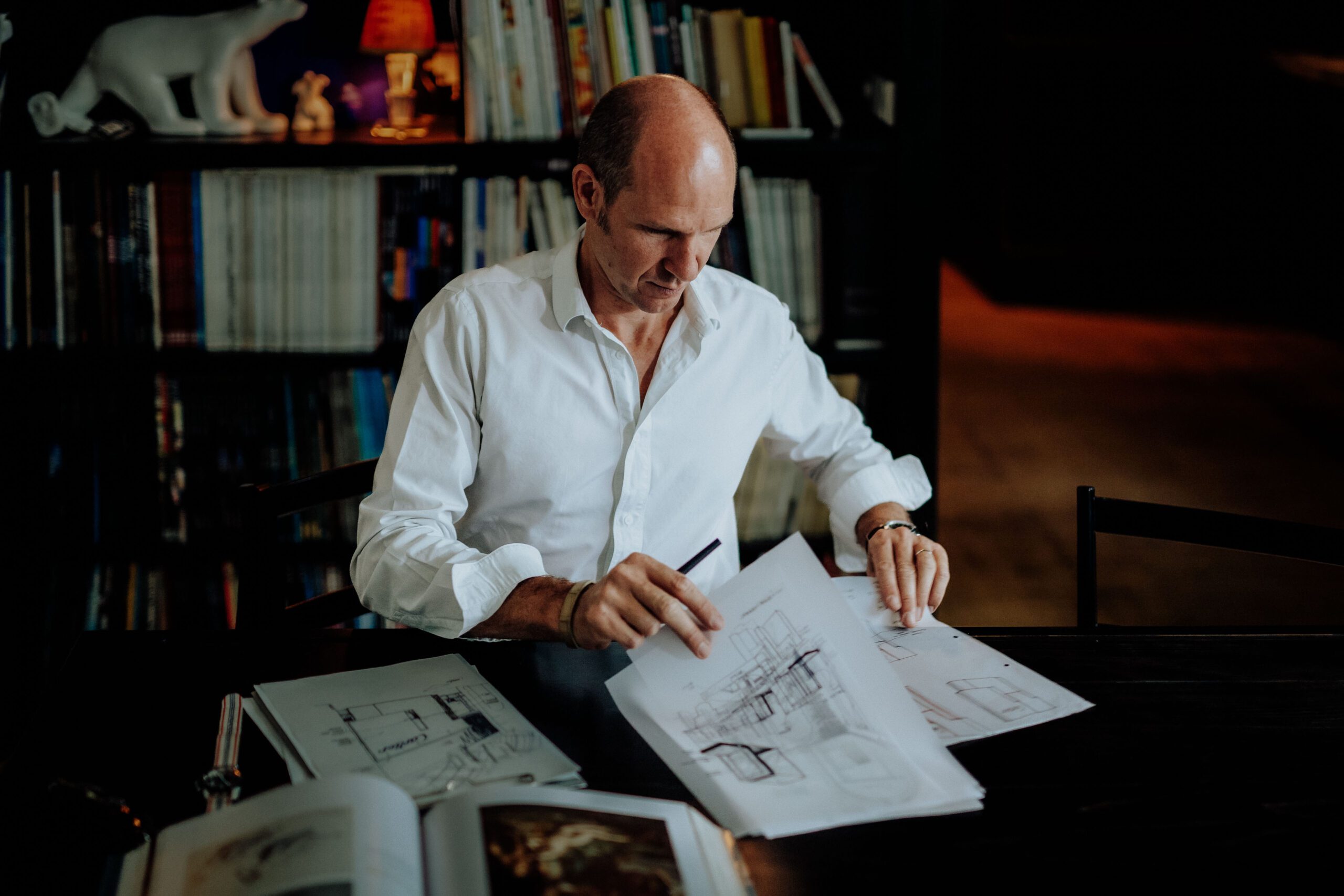 Portrait of Tristan Auer in his Montmartre home Portrait of French interior designer Tristan Auer working in his Montmartre studio room, surrounded by curated vintage furniture and natural light.