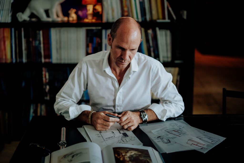 Portrait of Tristan Auer in his Montmartre home Portrait of French interior designer Tristan Auer working in his Montmartre studio room, surrounded by curated vintage furniture and natural light.