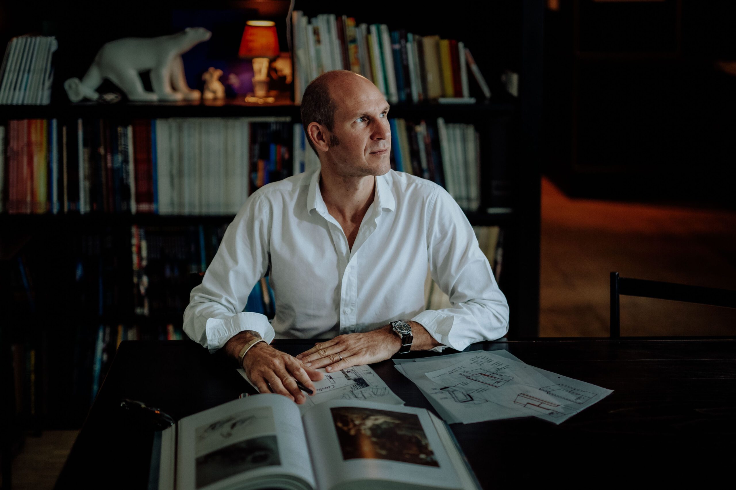 Portrait of Tristan Auer in his Montmartre home Portrait of French interior designer Tristan Auer working in his Montmartre studio room, surrounded by curated vintage furniture and natural light.