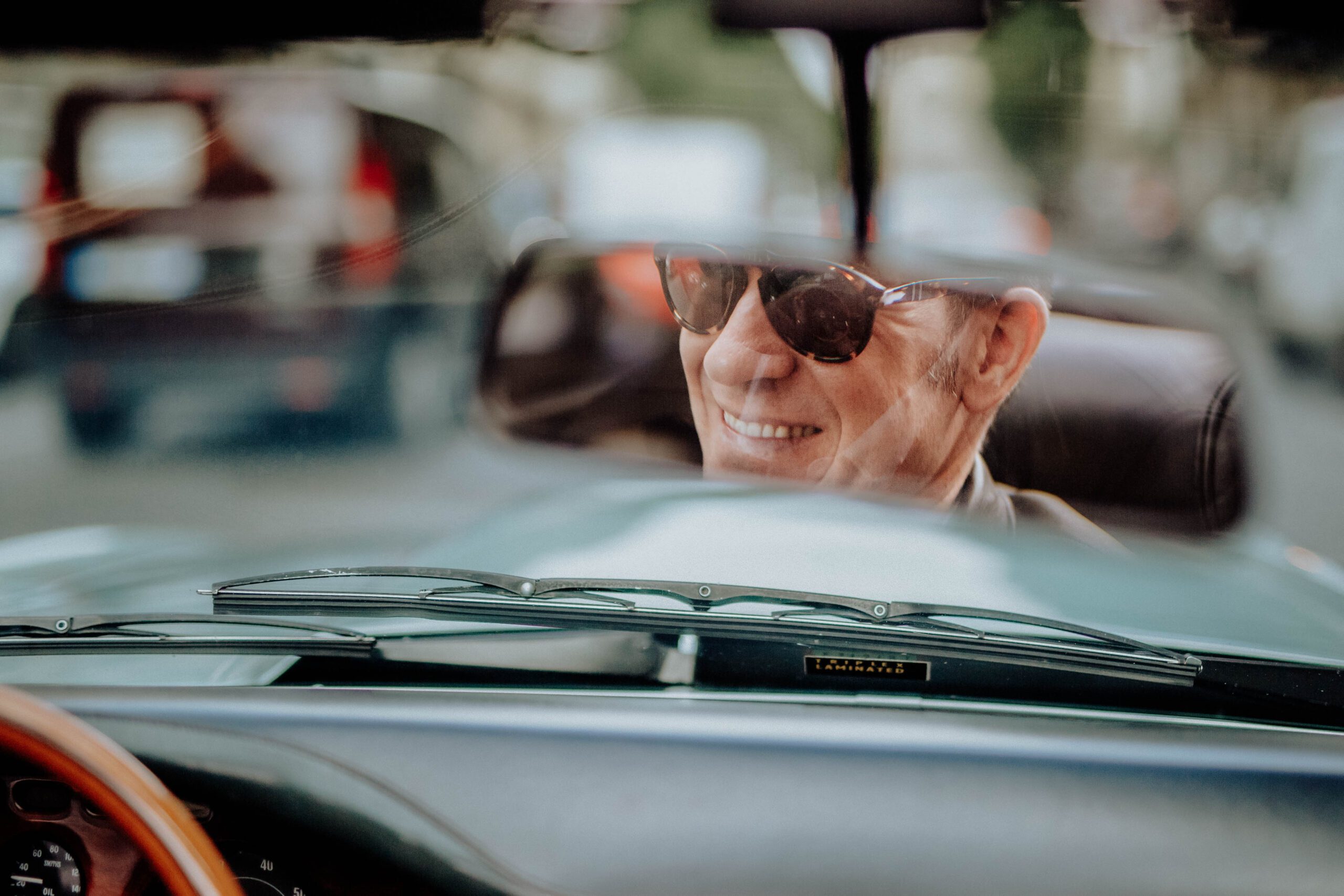 Interior view of Tristan Auer’s vintage Aston Martin as he drives through central Paris, captured during a candid lifestyle shoot.