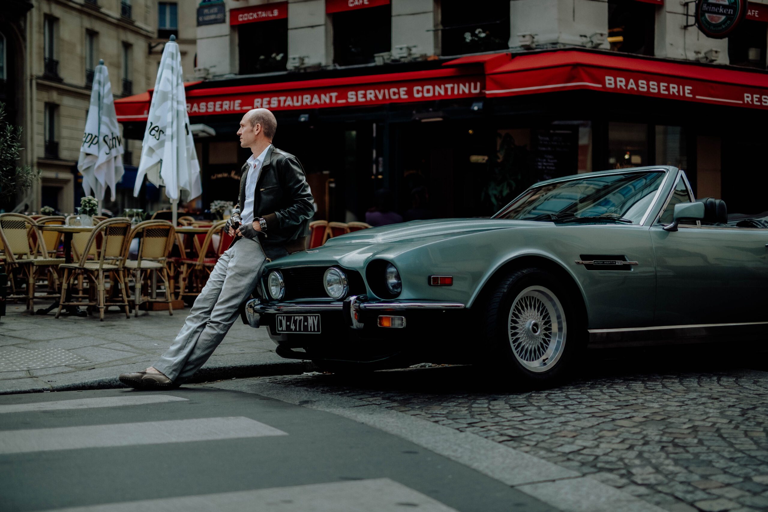 Tristan with vintage Aston Martin Tristan Auer standing next to his vintage Aston Martin in Paris during a lifestyle branding shoot for Wilson Associates.