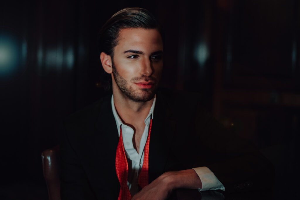 a groom posing as a hopeless romantic gazing at his bride