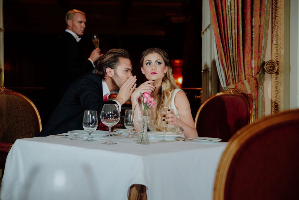 Couple posing in vintage Gatsby-inspired outfits at the Adolphus Hotel in downtown Dallas