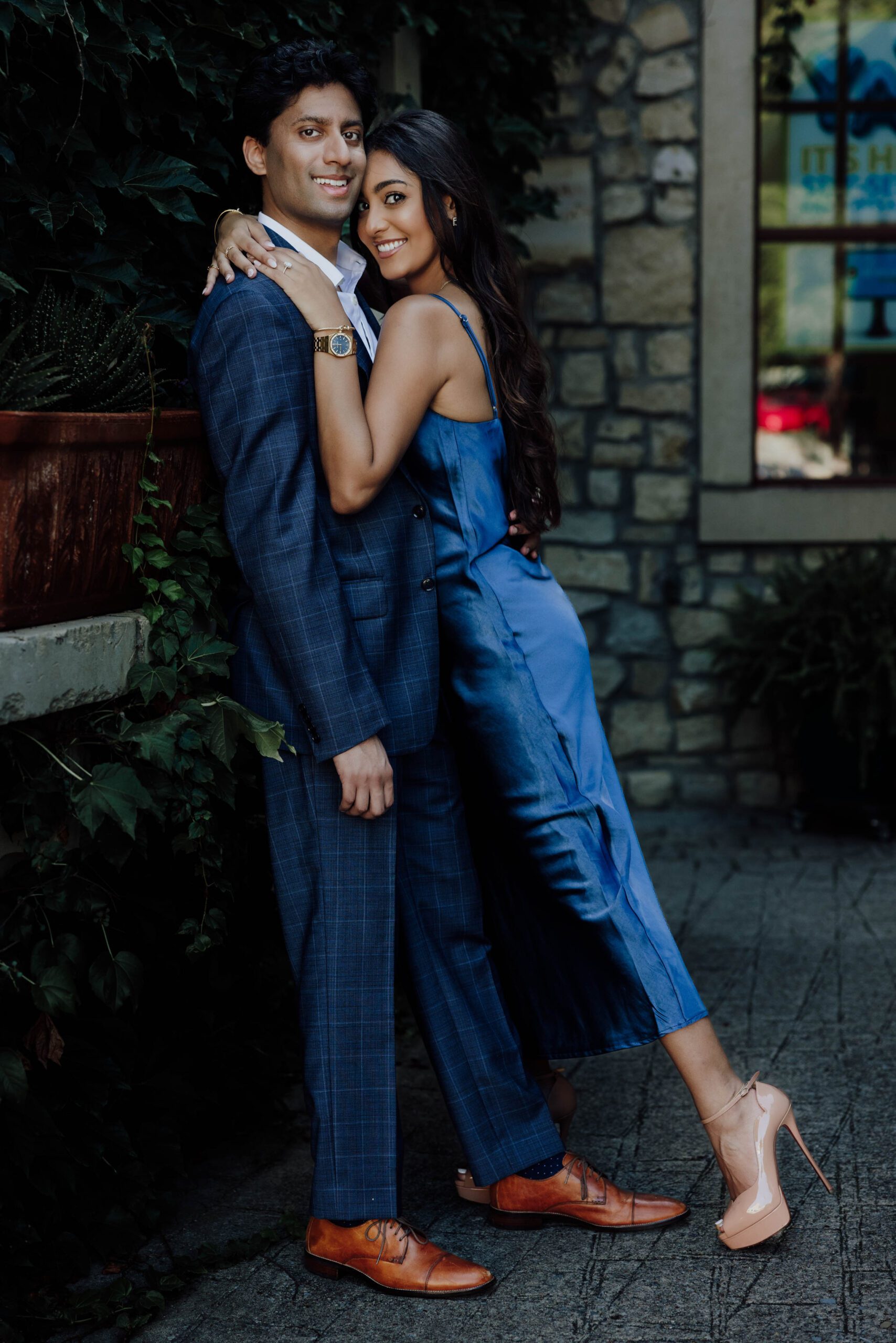 couple fun poses during their engagement session at the adriatica in mckinney texas