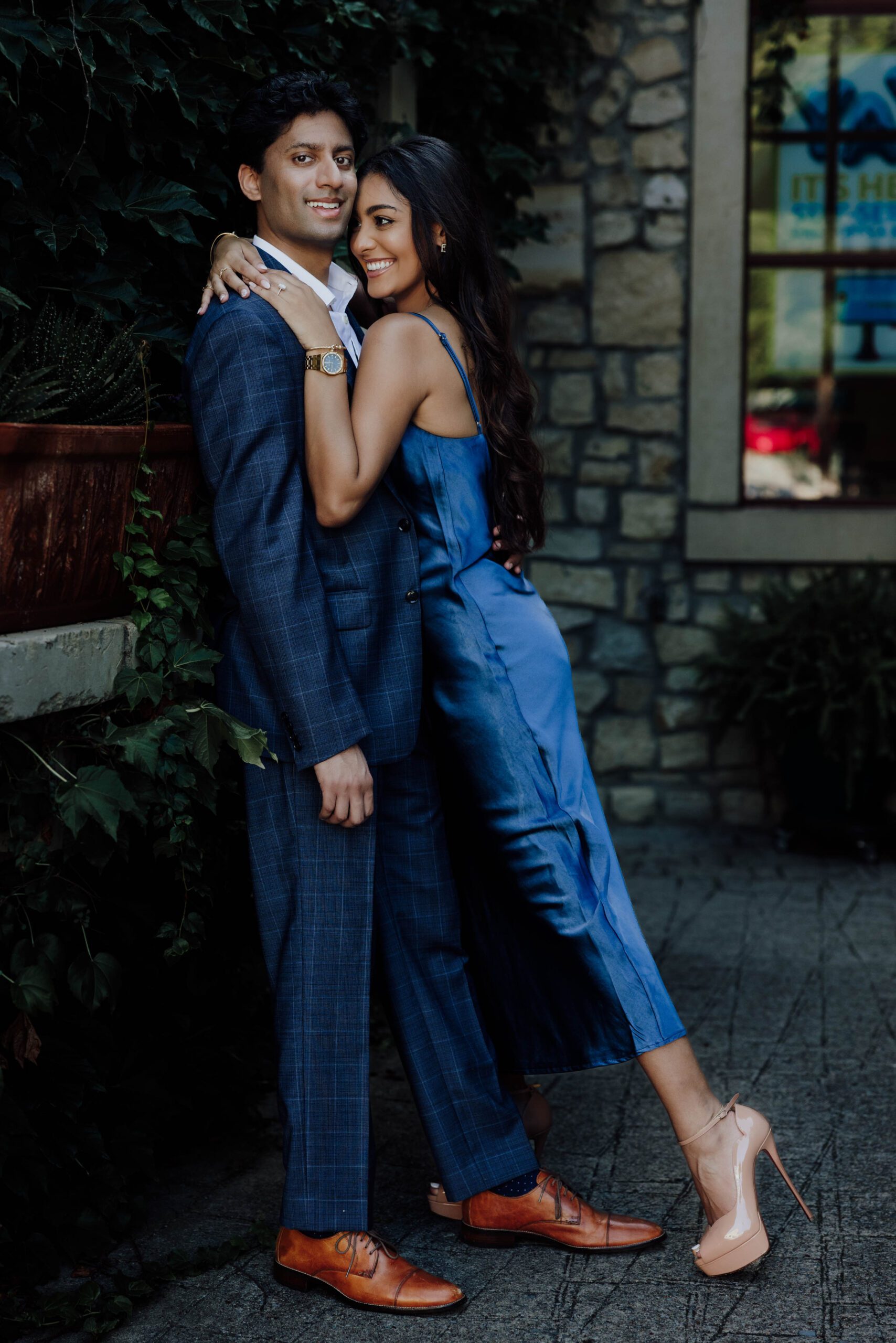 couple fun poses during their engagement session at the adriatica in mckinney texas