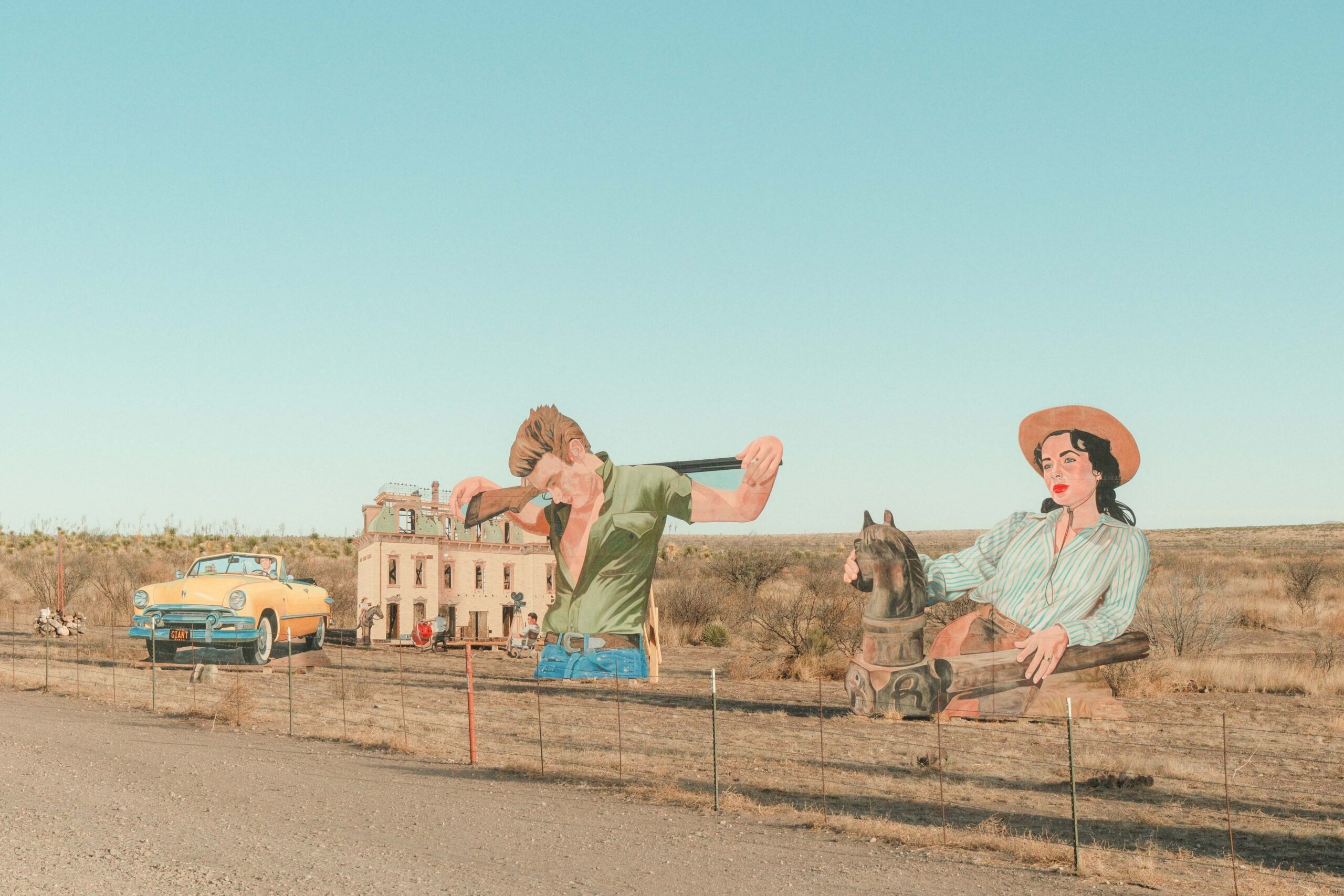 Giant Marfa mural wooden cutouts located on highway 90 between marfa and valentine featuring james dean and elizabeth taylor from their 1956 movie